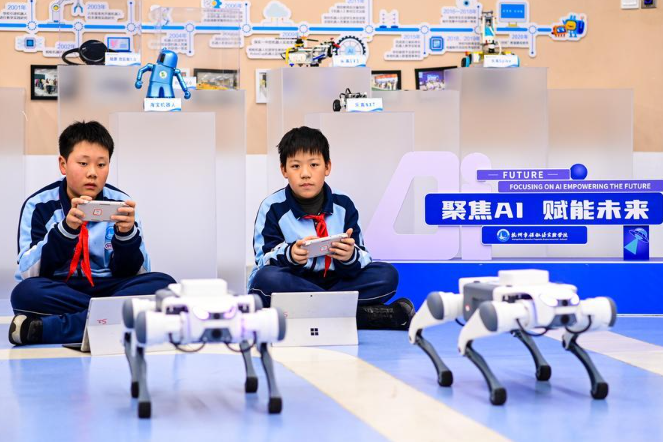 Students of Hangzhou Baochu Pagoda Experimental School learn to program robotic dogs during an AI course in Hangzhou, east China's Zhejiang Province, Dec. 2, 2025. (Xinhua/Jiang Han)